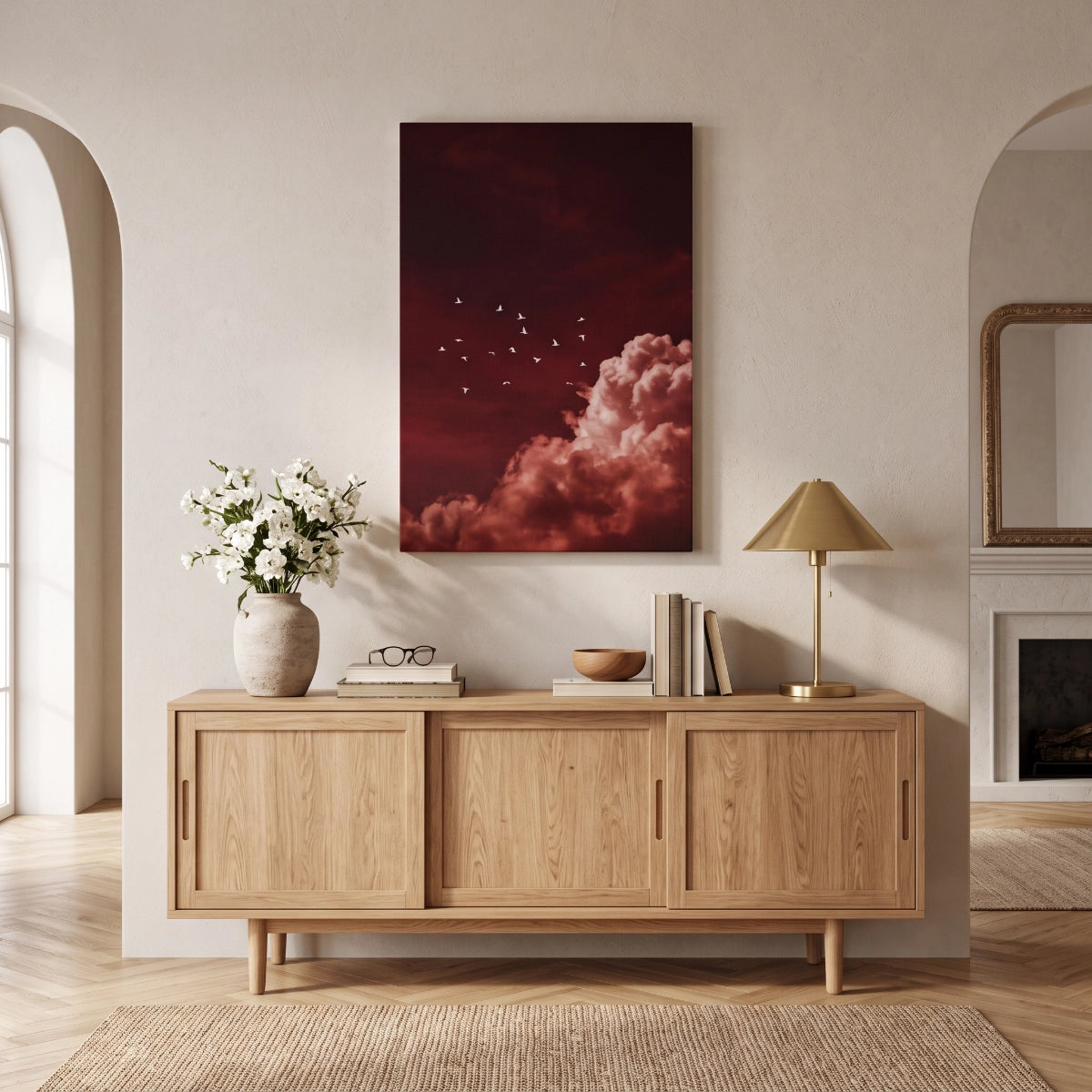 Cuadro de acento rojo colgado sobre una credenza de madera de roble claro en una sala contemporánea.